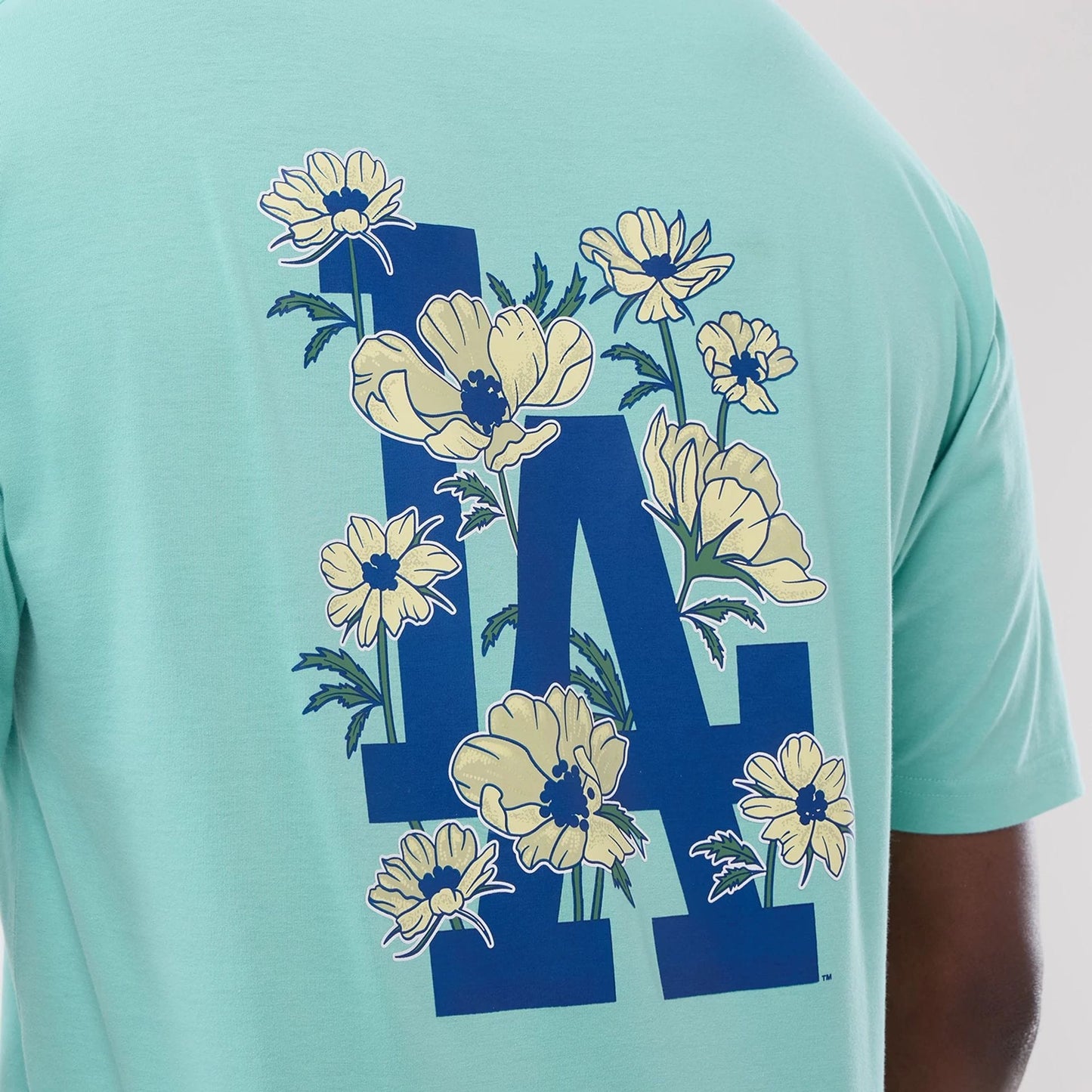 The model is wearing this MLB Floral LA Dodgers Oversized T-Shirt in pastel green. 4