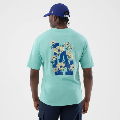 The model is wearing this MLB Floral LA Dodgers Oversized T-Shirt in pastel green. 2