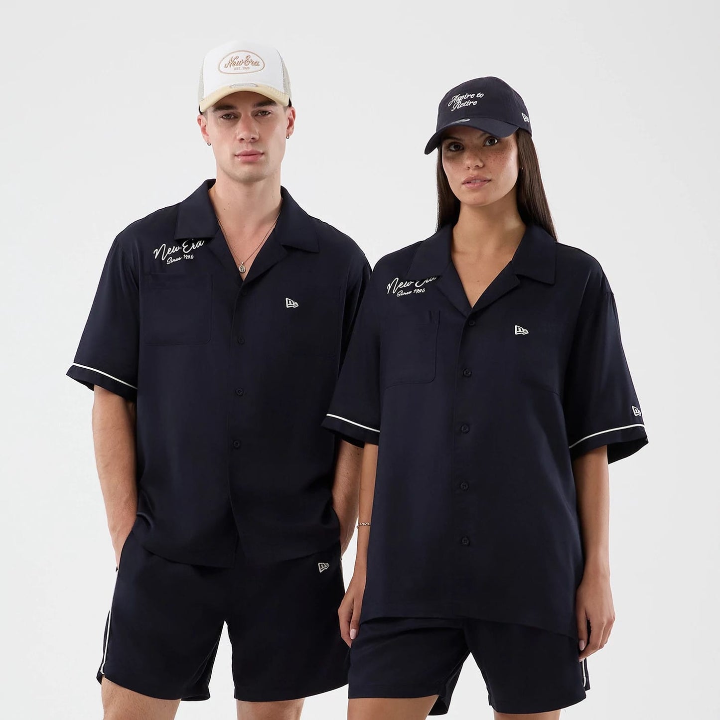 The model is wearing this New Era Graphic Revere Short Sleeve Shirt in navy. 1