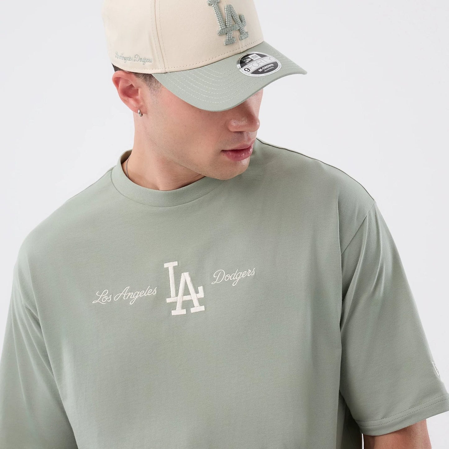 The model is wearing this MLB Script LA Dodgers Oversized T-Shirt in pastel green. 5