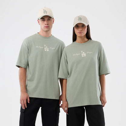 The model is wearing this MLB Script LA Dodgers Oversized T-Shirt in pastel green. 1