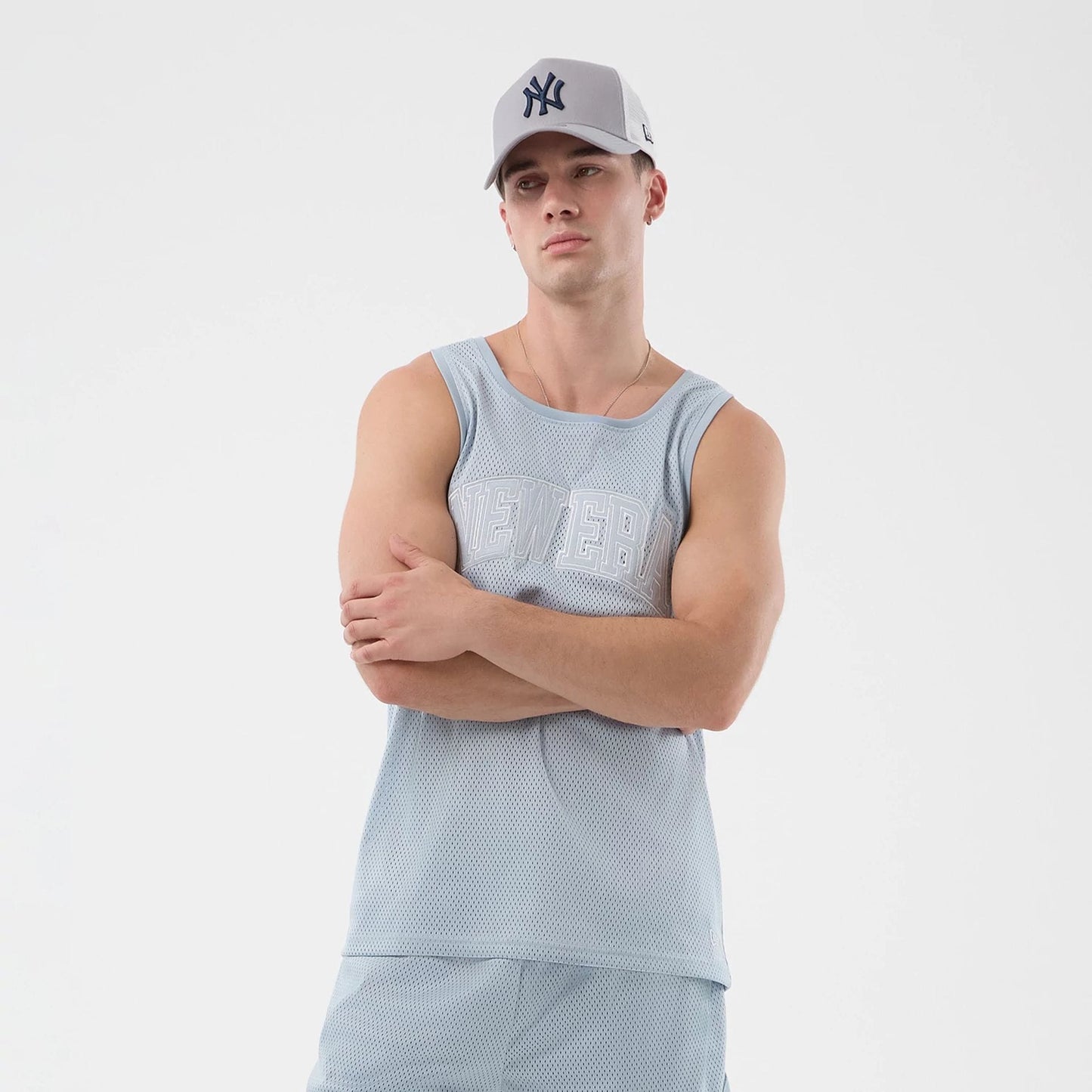 The model is wearing this New Era Mesh Oversized Tank Top in pastel blue. 6
