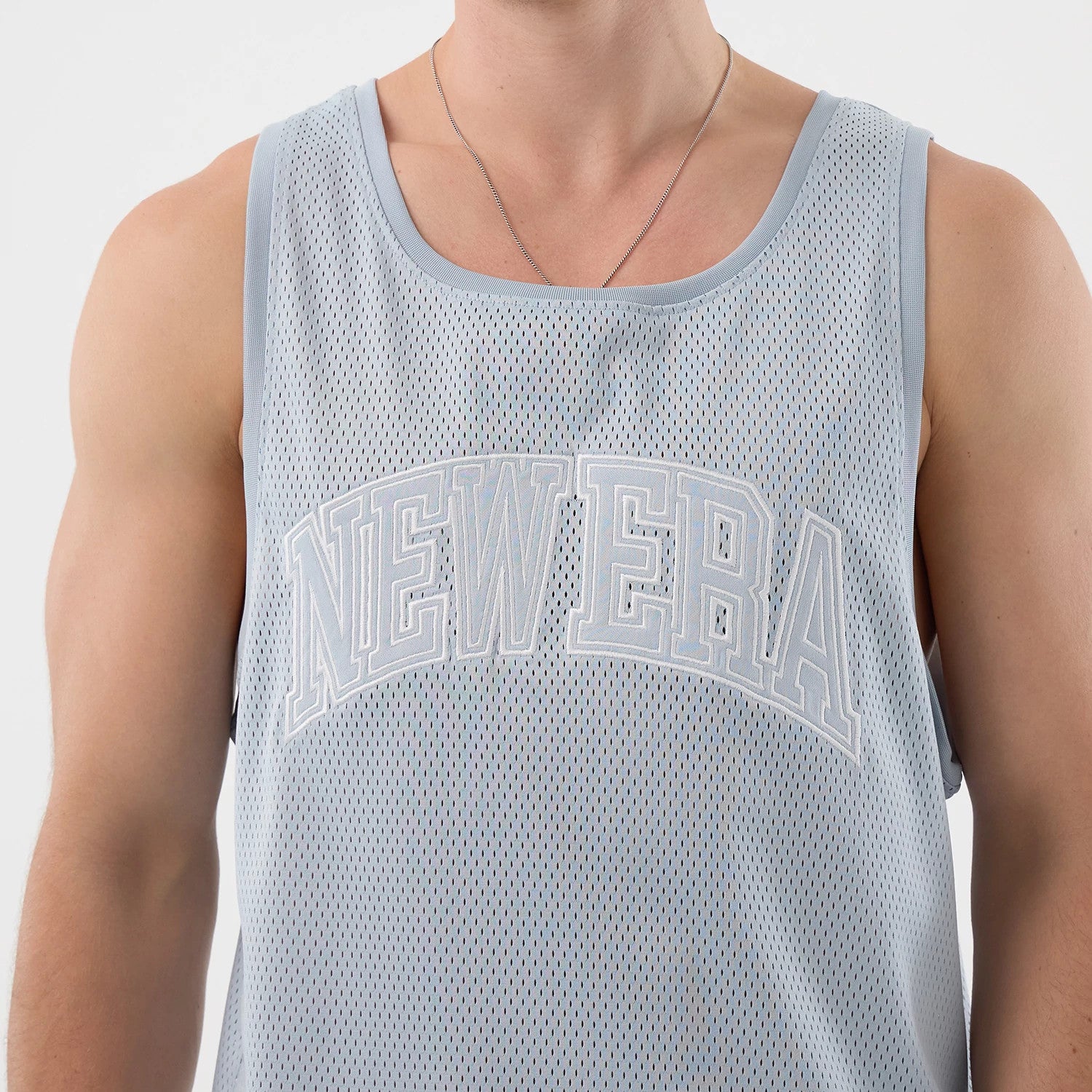 The model is wearing this New Era Mesh Oversized Tank Top in pastel blue. 3