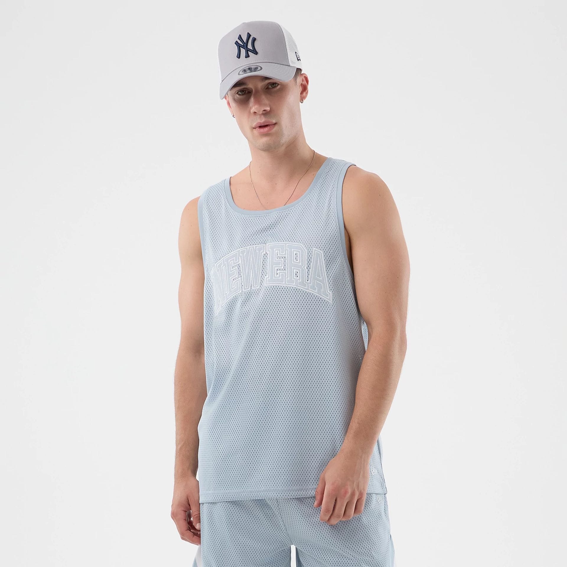 The model is wearing this New Era Mesh Oversized Tank Top in pastel blue. 1