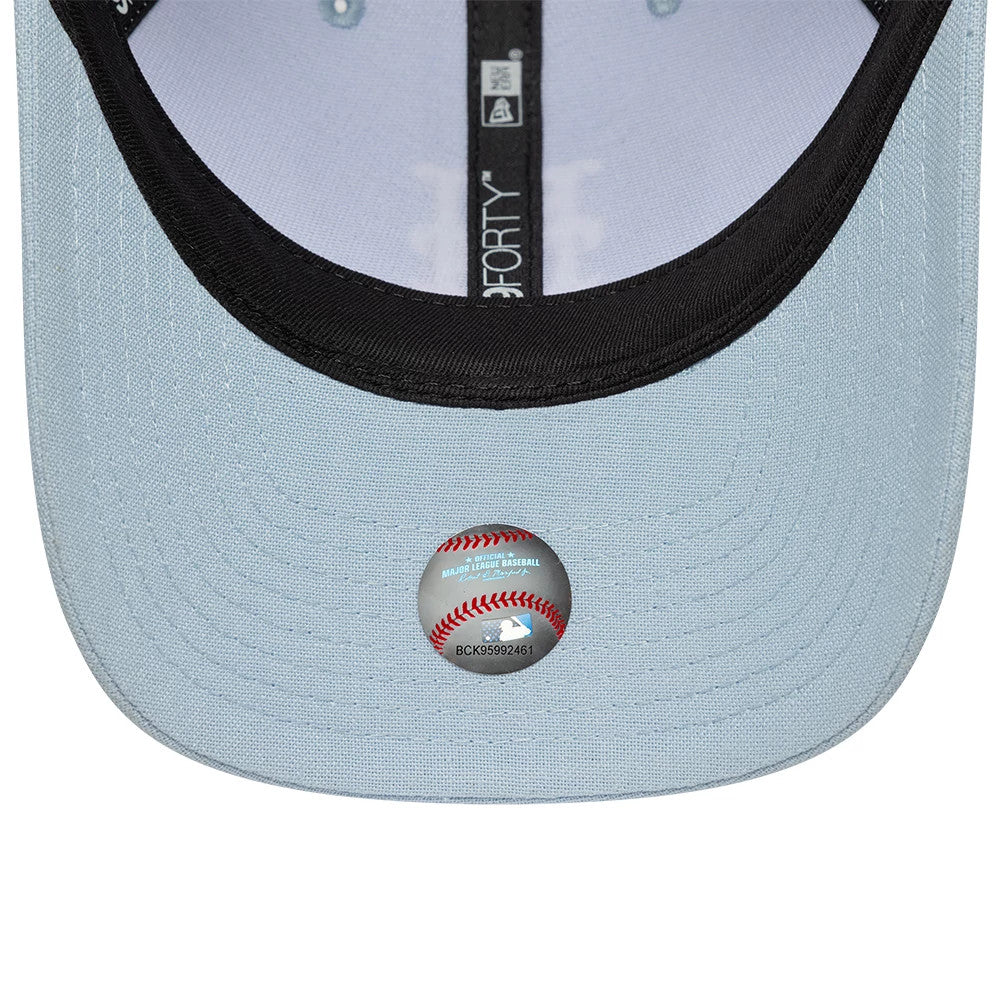 New York Mets MLB Linen Pastel Blue New Era 9FORTY M-Crown Adjustable Cap, inside view showing light blue undervisor with a transparent MLB size sticker featuring a baseball graphic, black sweatband, and branded taping along the interior seams.