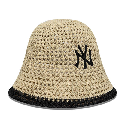 New Era New York Yankees Womens MLB Knitted Light Beige Explorer Bucket Hat, front view showing a black embroidered NY logo on the structured light beige knitted crown, highlighted by a contrasting black trim around the visor.