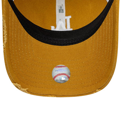 LA Dodgers MLB Cotton Canvas Beige New Era 9TWENTY Trucker Adjustable Cap, inside view showing a black undervisor with a round baseball-themed sticker, white taping along the interior, and an embroidered LA logo peeking beneath the sweatband.
