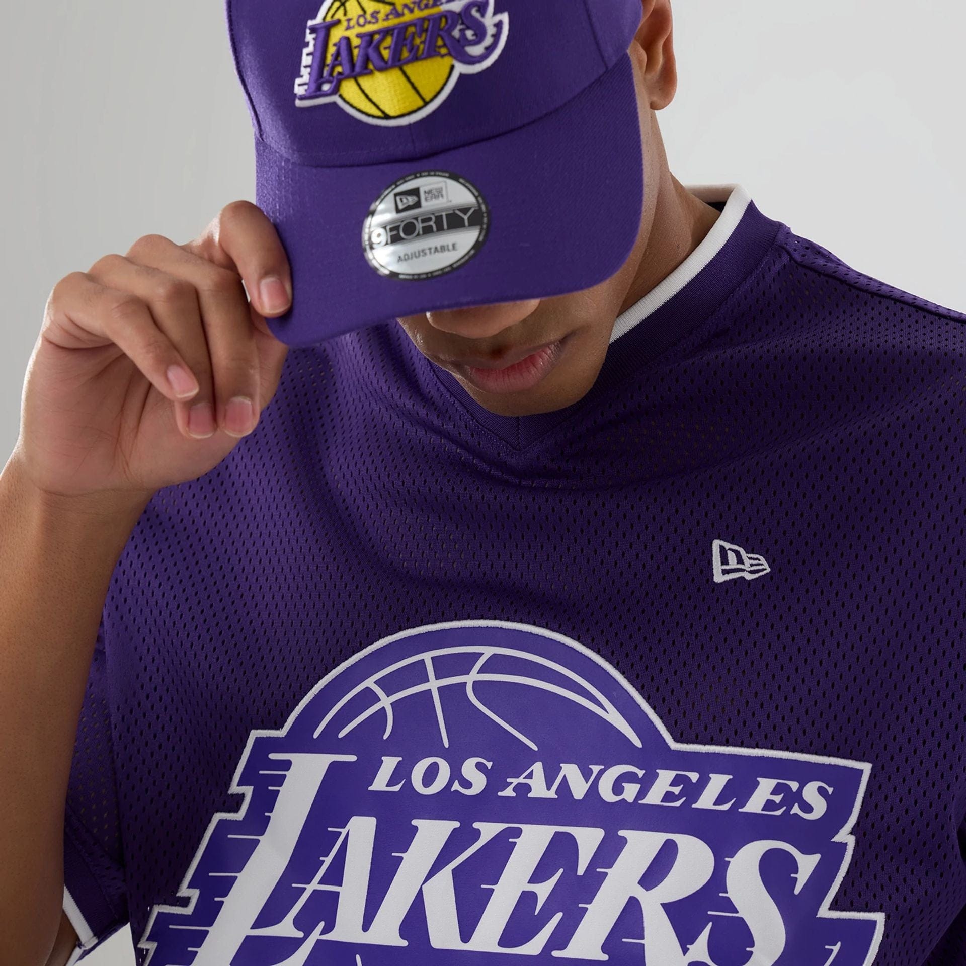 The model is wearing this NBA Mesh LA Lakers Oversized T-Shirt in purple. 3