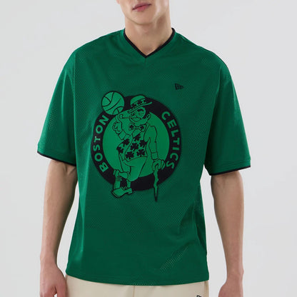 The model is wearing this NBA Mesh Boston Celtics Oversized T-Shirt in green. 4