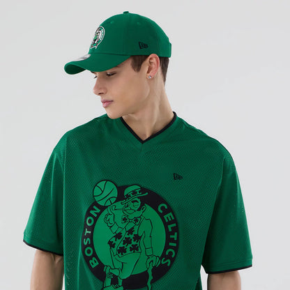 The model is wearing this NBA Mesh Boston Celtics Oversized T-Shirt in green. 6