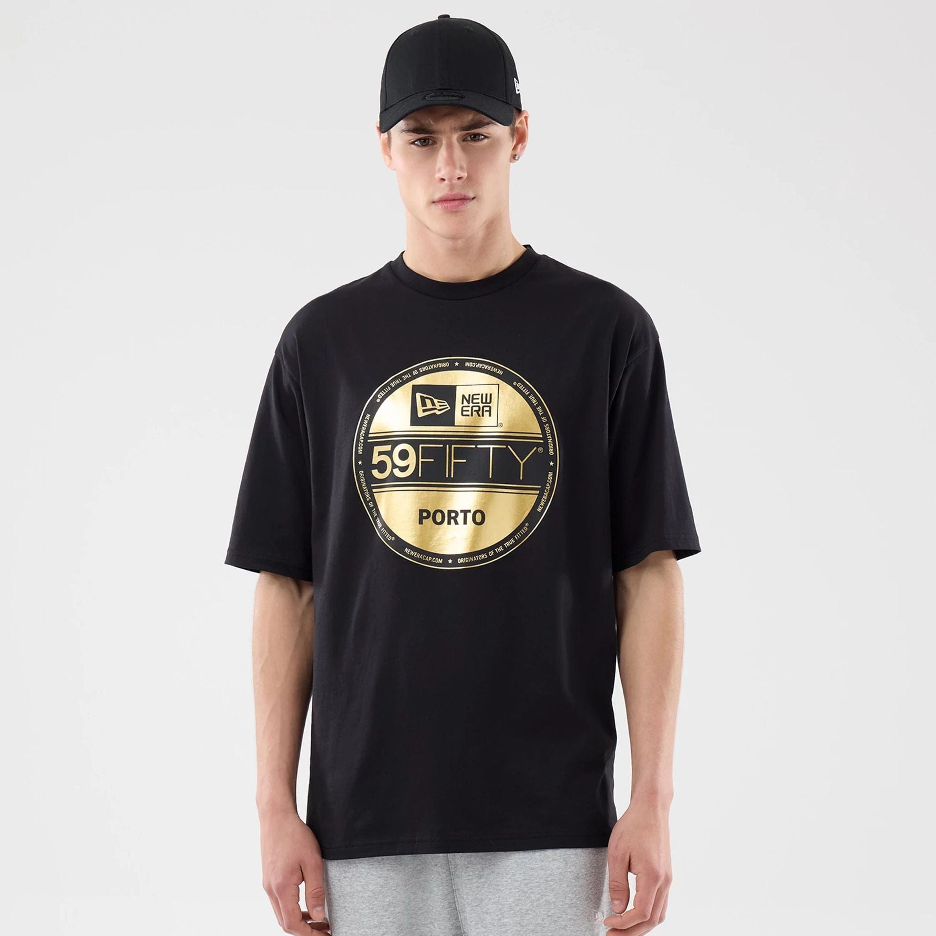The model is wearing this New Era Sticker Porto Oversized T-Shirt in black. 1