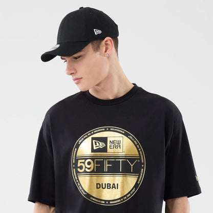 The model is wearing this New Era Sticker Dubai Oversized T-Shirt in black. 6