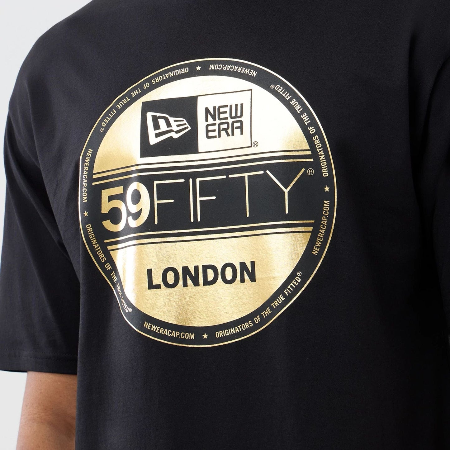 The model is wearing this New Era Sticker London Oversized T-Shirt in black. 3