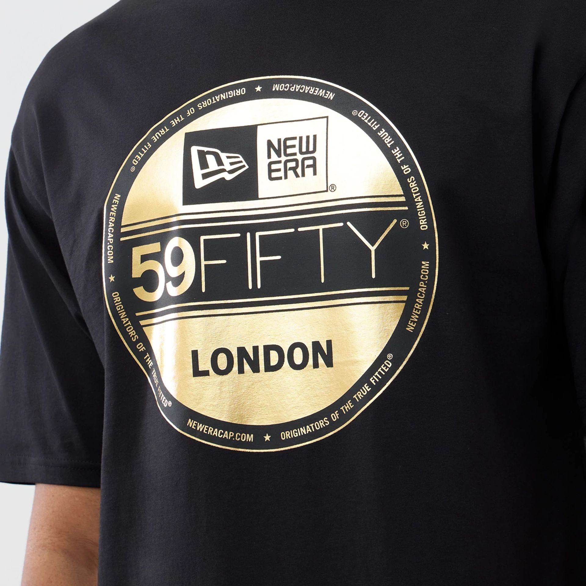 The model is wearing this New Era Sticker London Oversized T-Shirt in black. 3