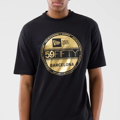 The model is wearing this New Era Sticker Barcelona Oversized T-Shirt in black. 4