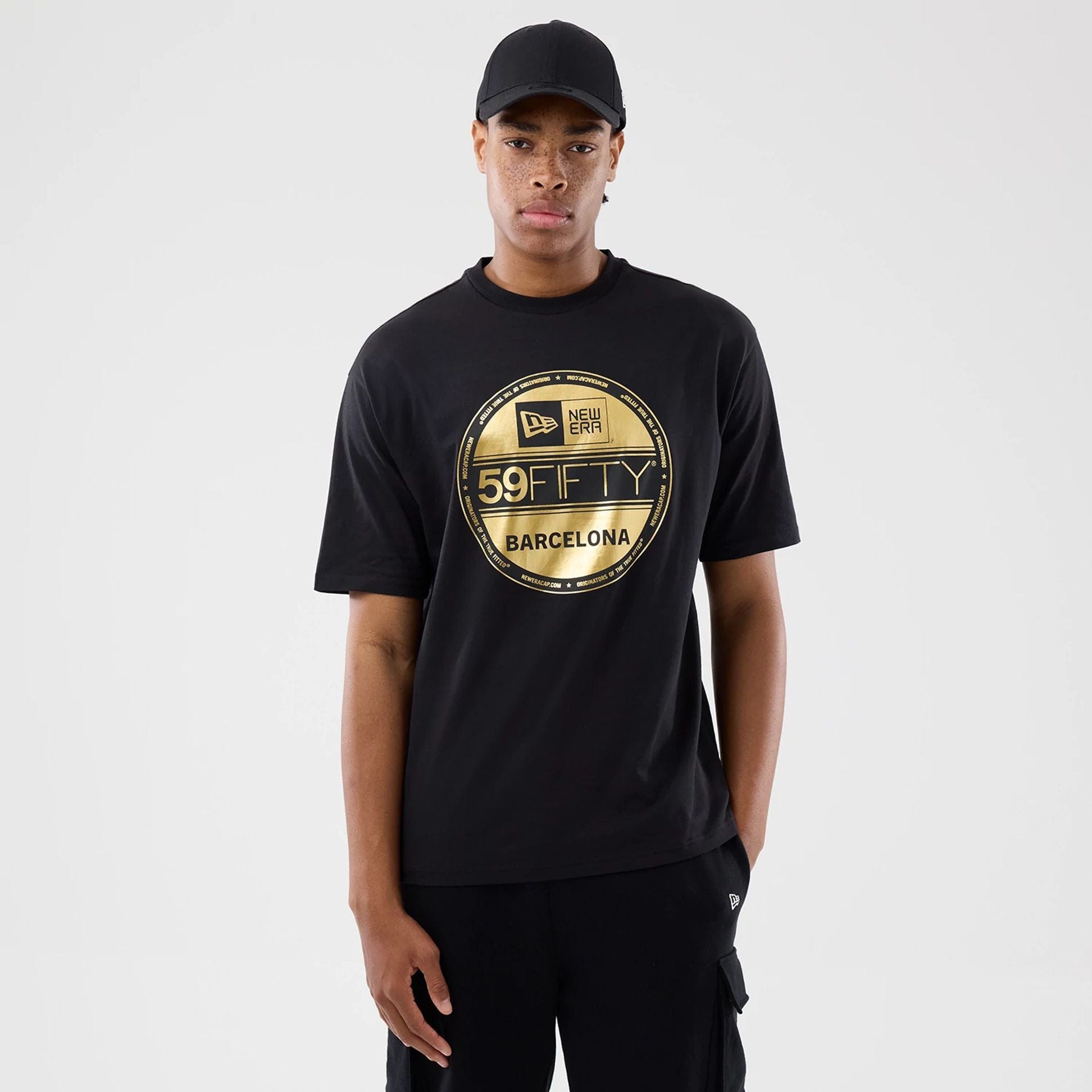 The model is wearing this New Era Sticker Barcelona Oversized T-Shirt in black. 1