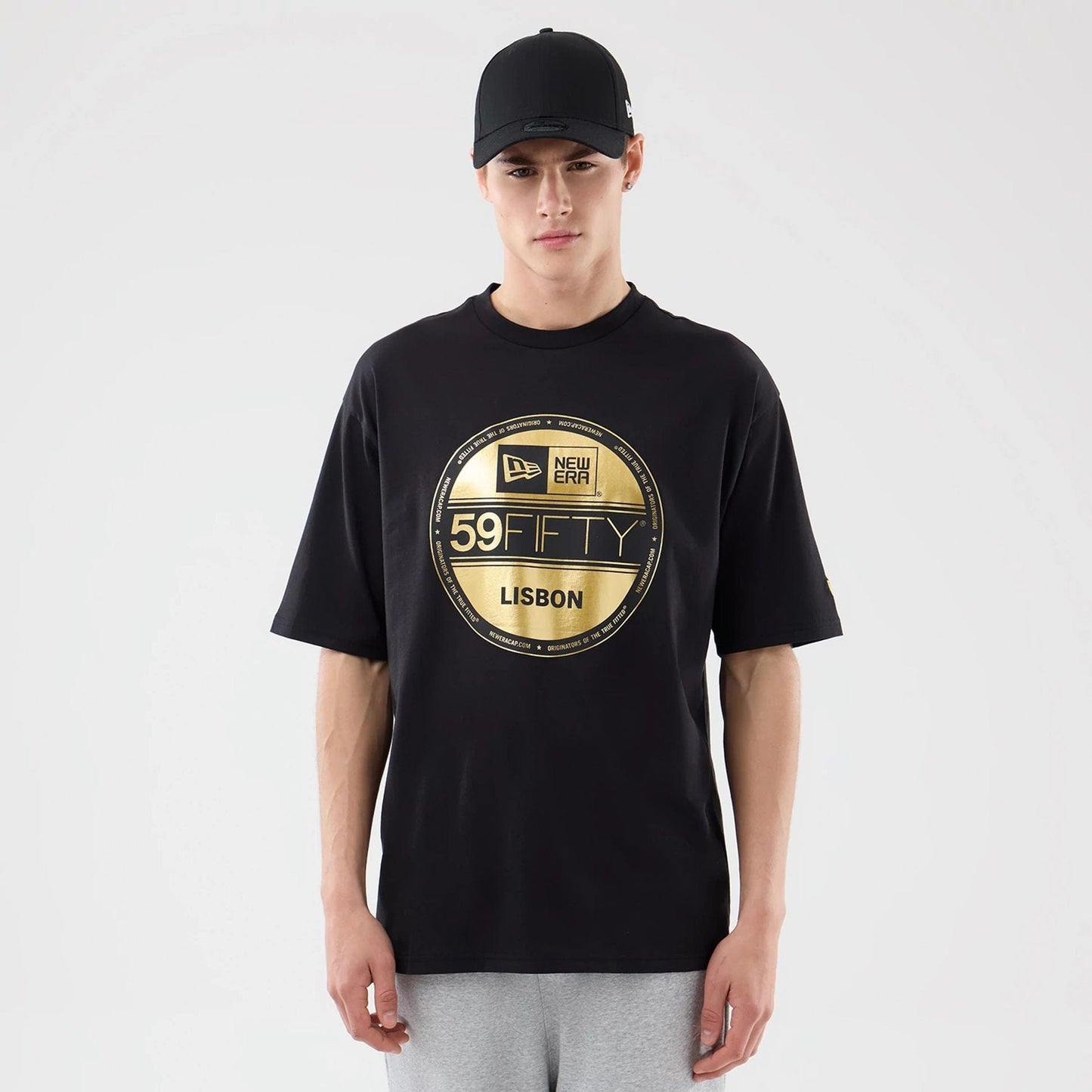 The model is wearing this New Era Sticker Lisbon Oversized T-Shirt in black. 1