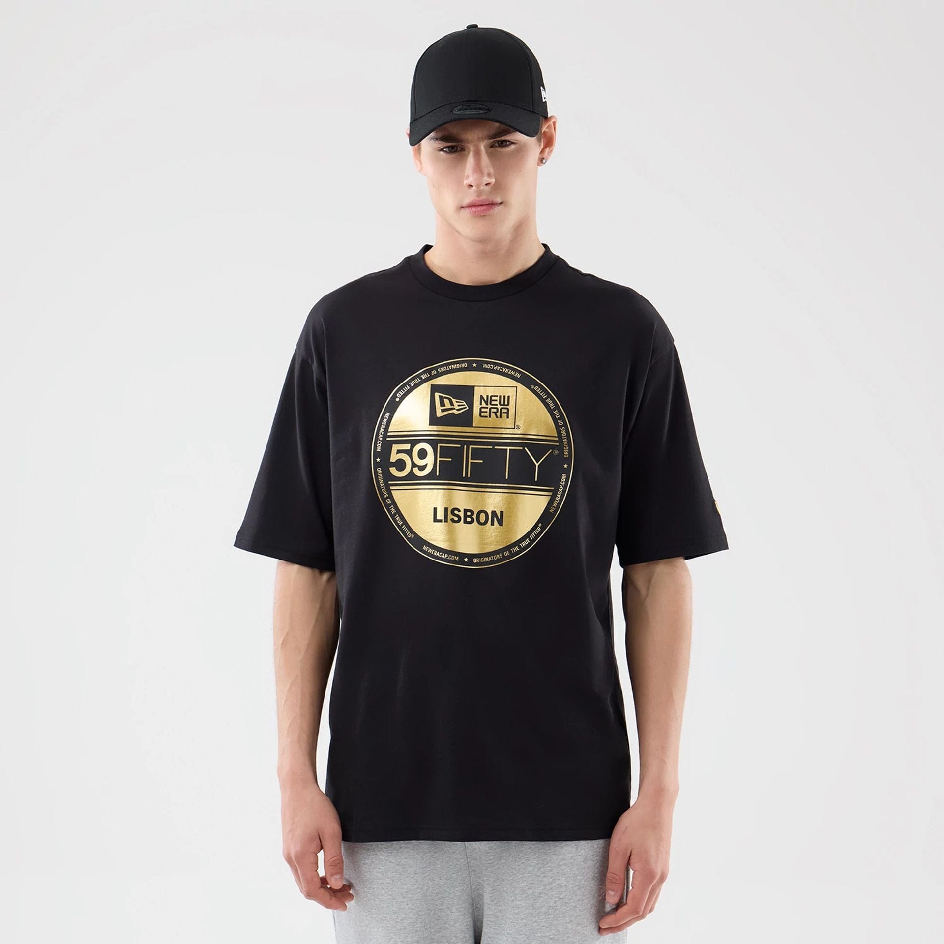 The model is wearing this New Era Sticker Lisbon Oversized T-Shirt in black. 1