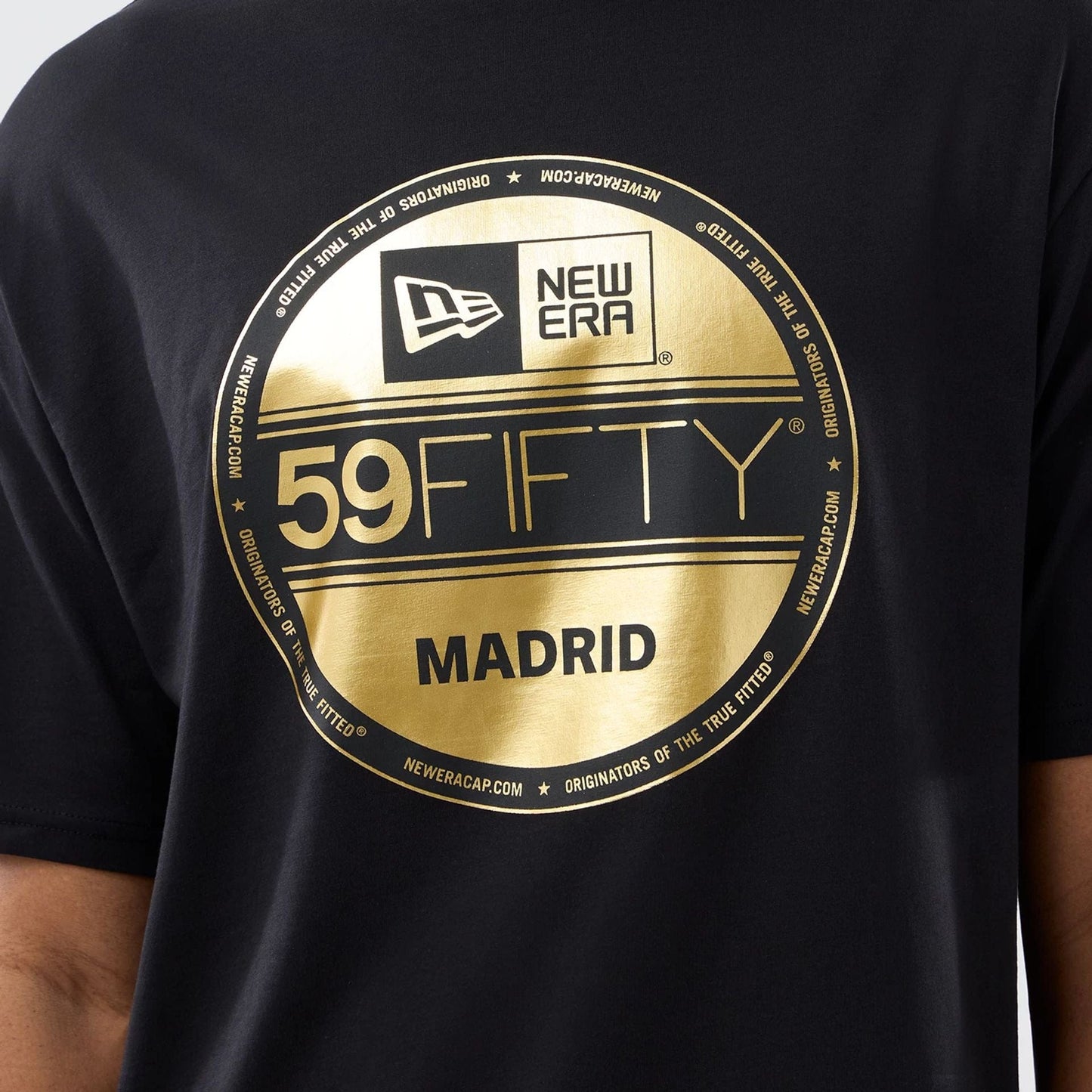 The model is wearing this New Era Sticker Madrid Oversized T-Shirt in black. 3