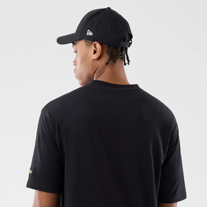 The model is wearing this New Era Sticker Madrid Oversized T-Shirt in black. 7