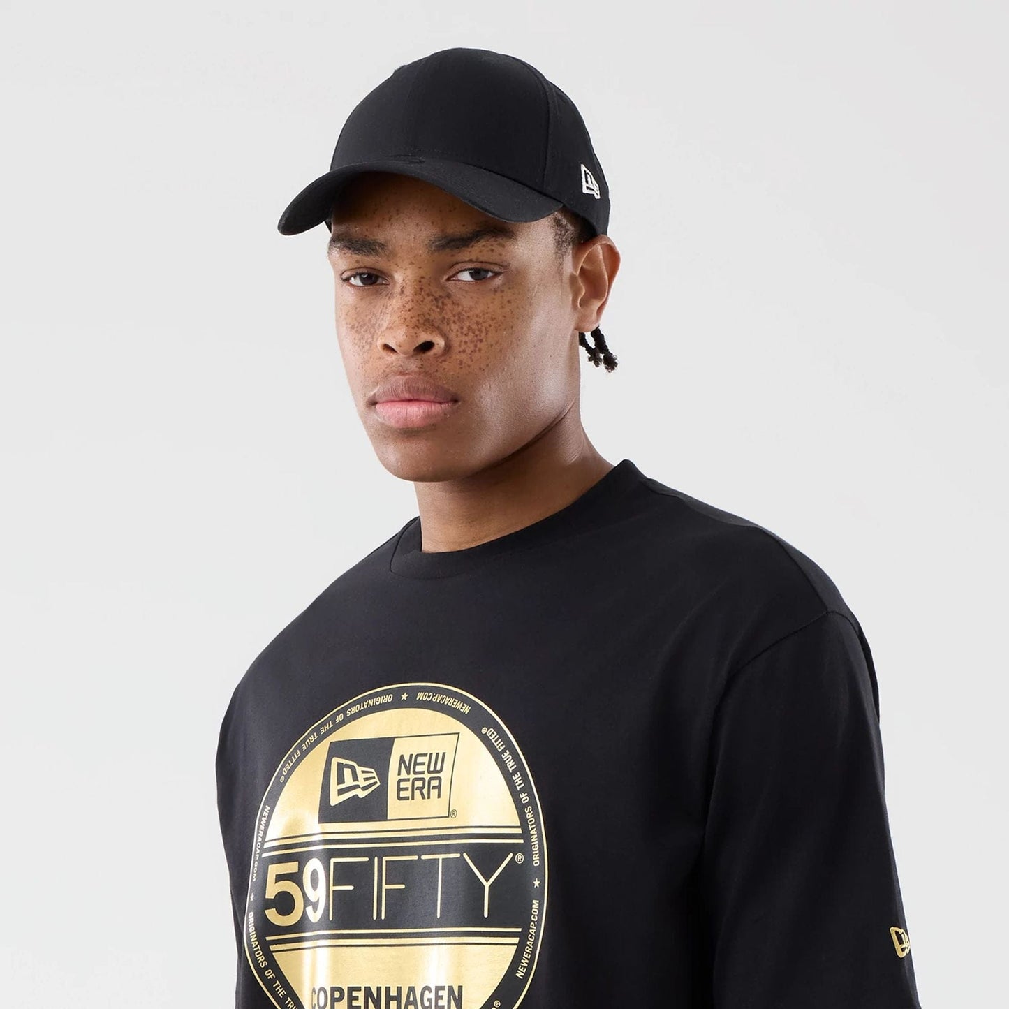 The model is wearing this New Era Sticker Copenhagen Oversized T-Shirt in black. 6