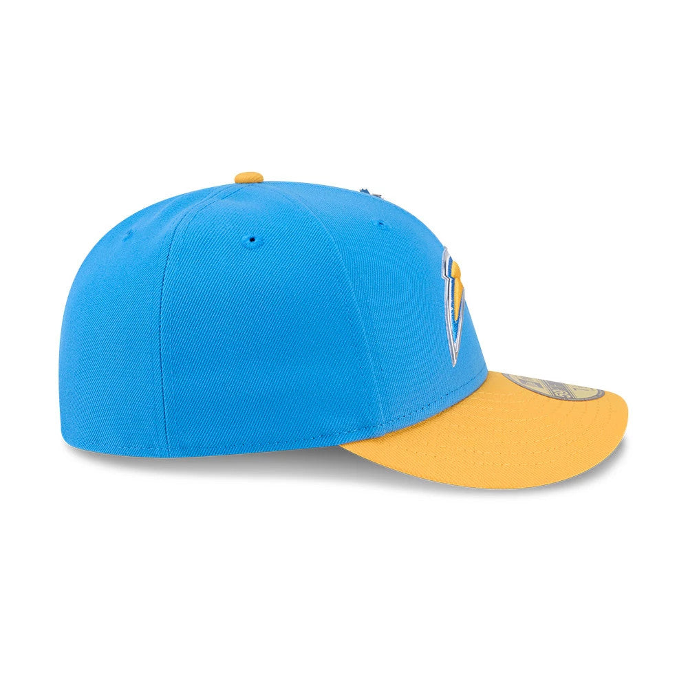 LA Chargers NFL Draft 2026 Blue New Era 59FIFTY Fitted Cap, side view showing the gold New Era flag logo embroidered on the left side of the structured sky-blue crown, with a curved gold visor and gold 59FIFTY size sticker on top.