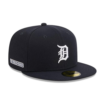 Detroit Tigers MLB City Connect Black New Era 59FIFTY Fitted Cap, three-quarter view showing the raised white embroidered team logo on the front panel, a flat black visor with a gold 59FIFTY size sticker, and a patch on the side.