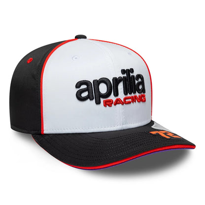 Aprilia Replica Marco Bezzecchi White New Era 9SEVENTY Stretch Snap Adjustable Cap, three-quarter view showing the black and red raised embroidered Aprilia Racing logo on the white front panels, black curved visor with the orange number 72.