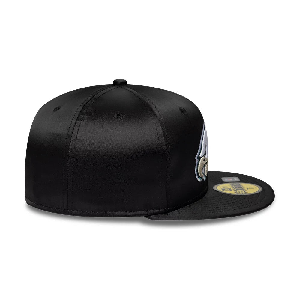 Philadelphia Eagles NFL Satin Black New Era 59FIFTY Fitted Cap, side view showing the embroidered Eagles logo on the front panel, satin finish on the structured black crown, and gold 59FIFTY size sticker on the flat black visor.