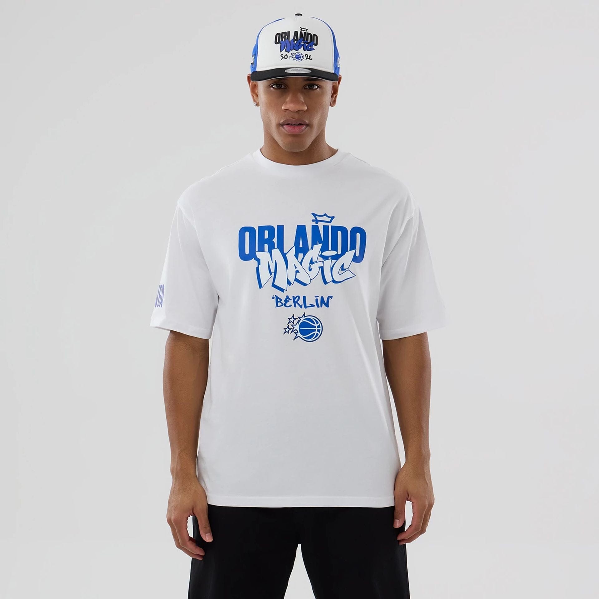 The model is wearing this NBA Berlin Game 2026 Orlando Magic Oversized T-Shirt in white. 1