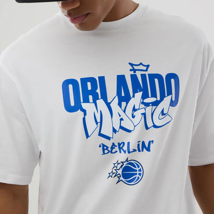 The model is wearing this NBA Berlin Game 2026 Orlando Magic Oversized T-Shirt in white. 5