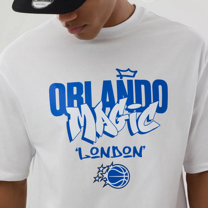 The model is wearing this NBA London Game 2026 Orlando Magic Oversized T-Shirt in white. 4