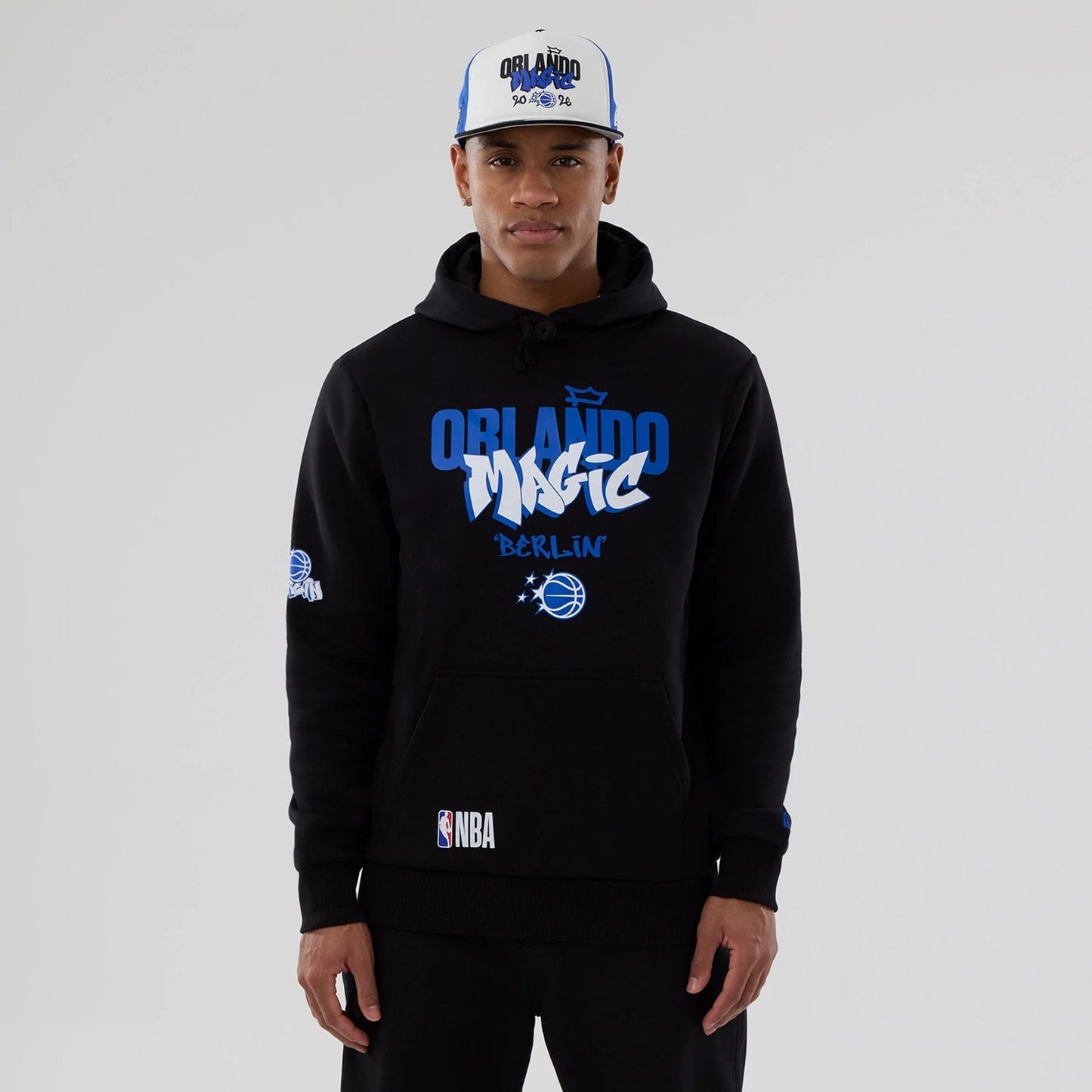 The model is wearing this NBA Berlin Game 2026 Orlando Magic Pullover Hoodie in black. 1