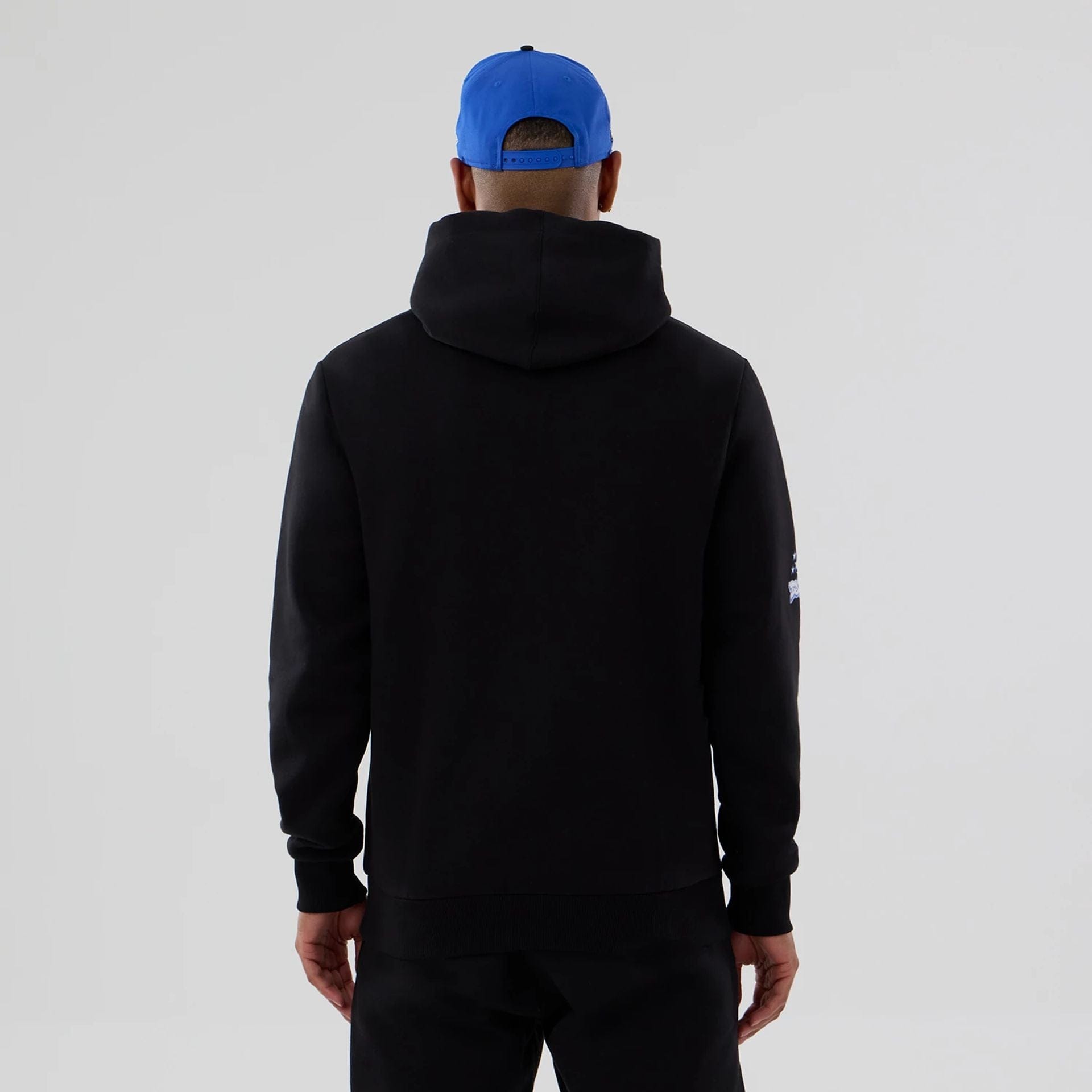 The model is wearing this NBA Berlin Game 2026 Orlando Magic Pullover Hoodie in black. 2