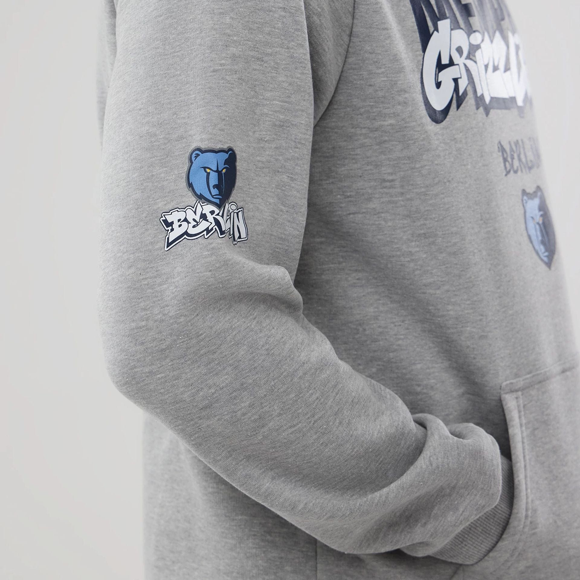 The model is wearing this NBA Berlin Game 2026 Memphis Grizzlies Pullover Hoodie in grey. 3