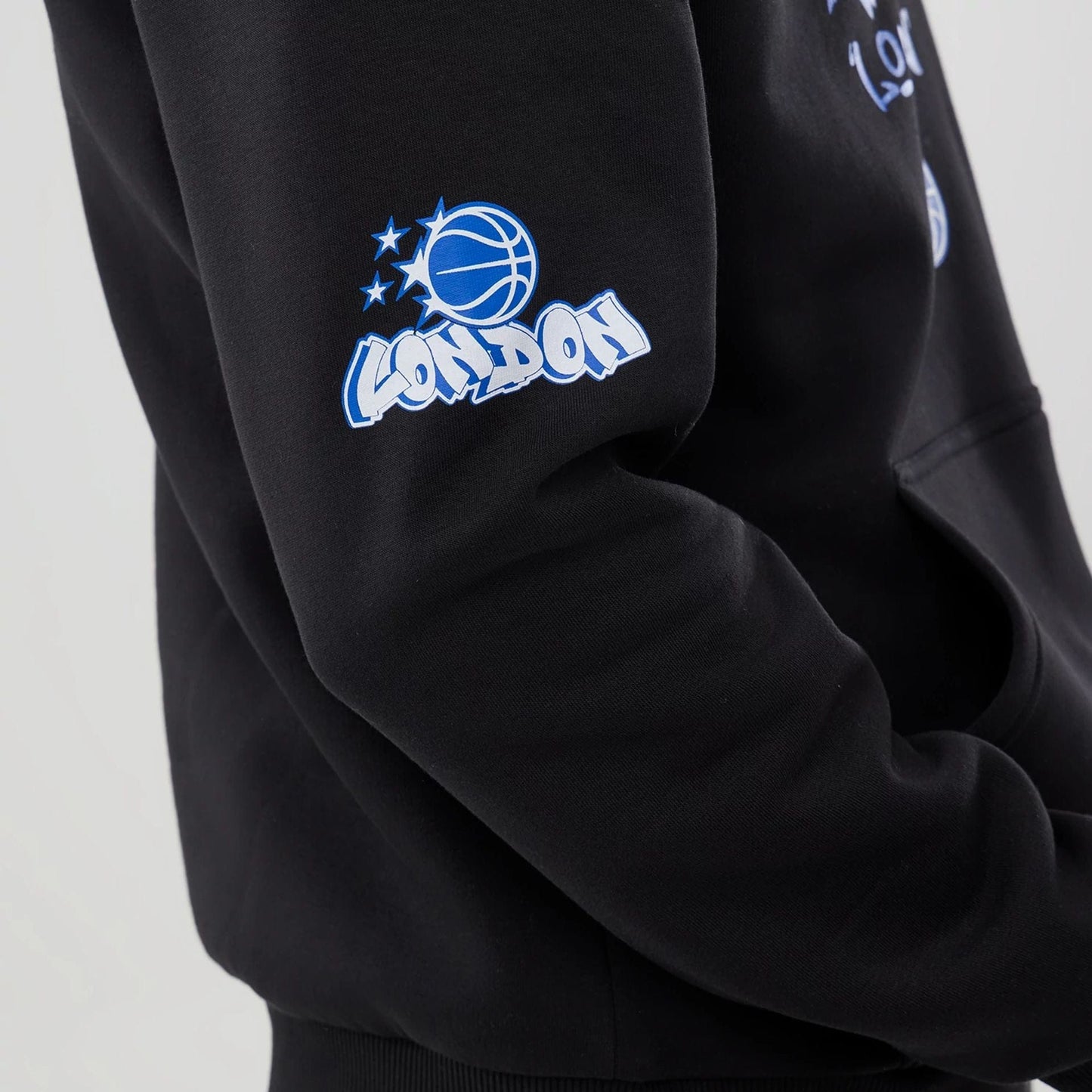 The model is wearing this NBA London Game 2026 Orlando Magic Pullover Hoodie in black. 6