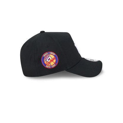 Yankees MLB Cooperstown Anniversary Black New Era 9FORTY A-Frame Adjustable Cap, side view showing the red and gold Yankees anniversary patch embroidered on the side panel, a curved black visor, and the 9FORTY size sticker on the top of the visor.