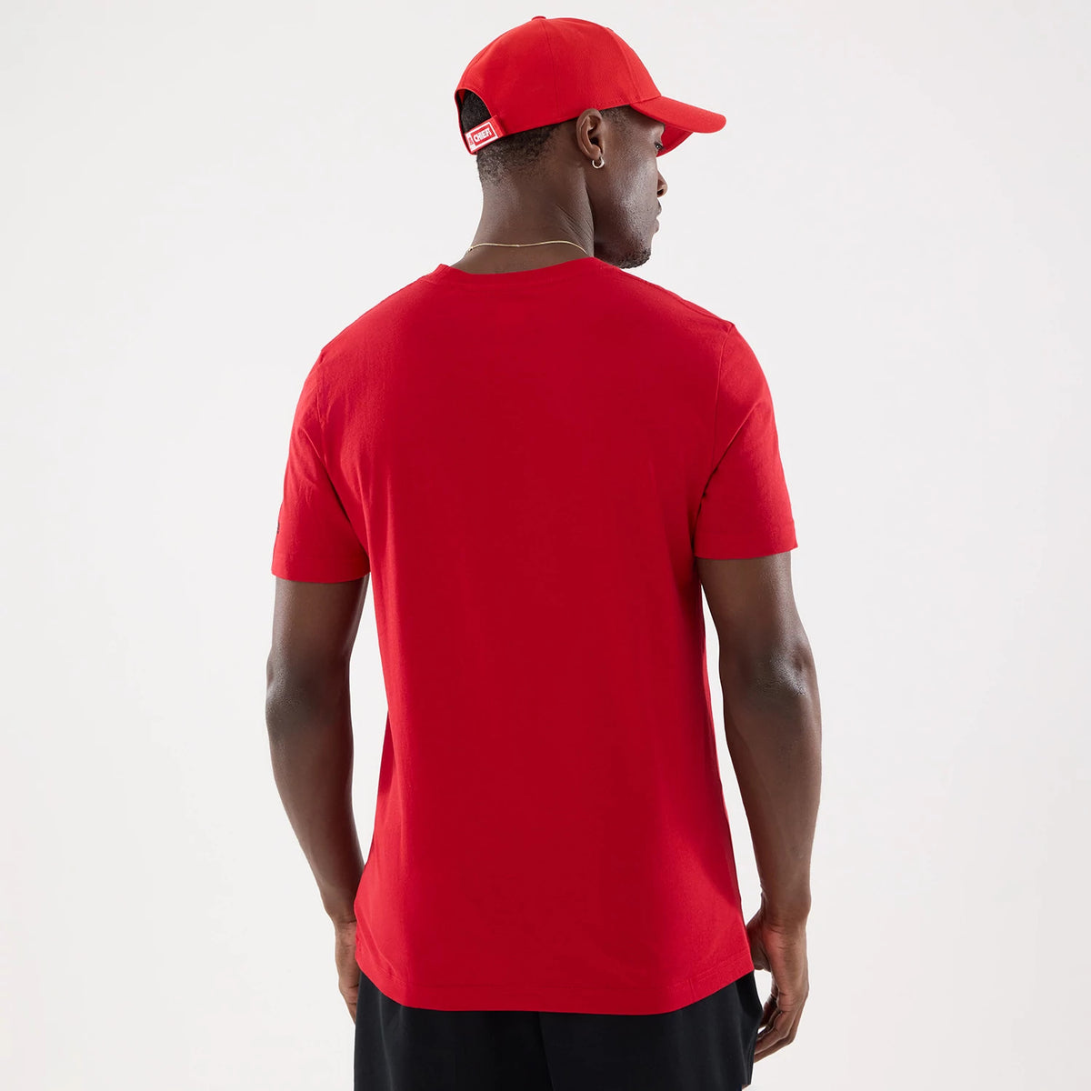 New Era Kansas City Chiefs NFL Training 2026 Red T-Shirt, back view on a model wearing a matching red cap, showcasing a plain red back with short sleeves, clean lines, and a relaxed fit with a crew neck style.