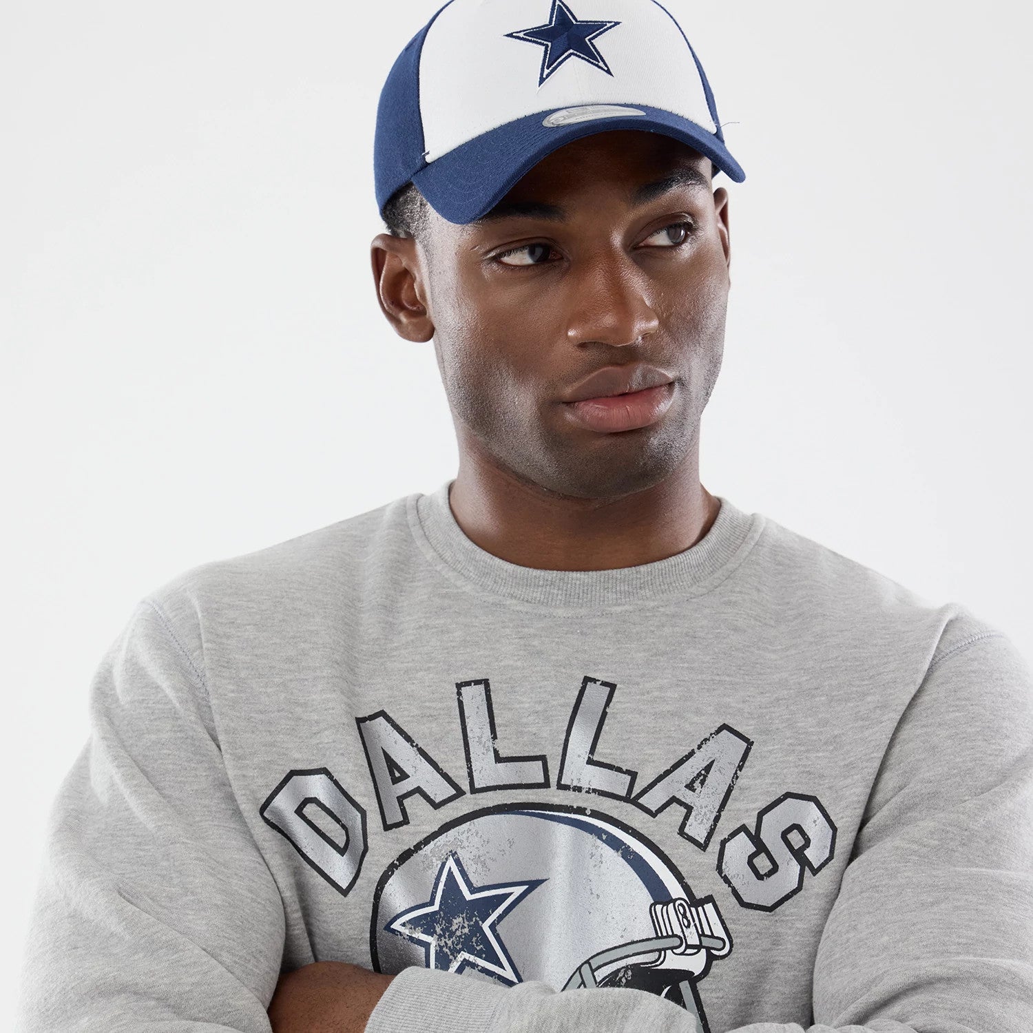 The model is wearing this NFL Training 2026 Dallas Cowboys Crew Neck Sweater in grey. 4