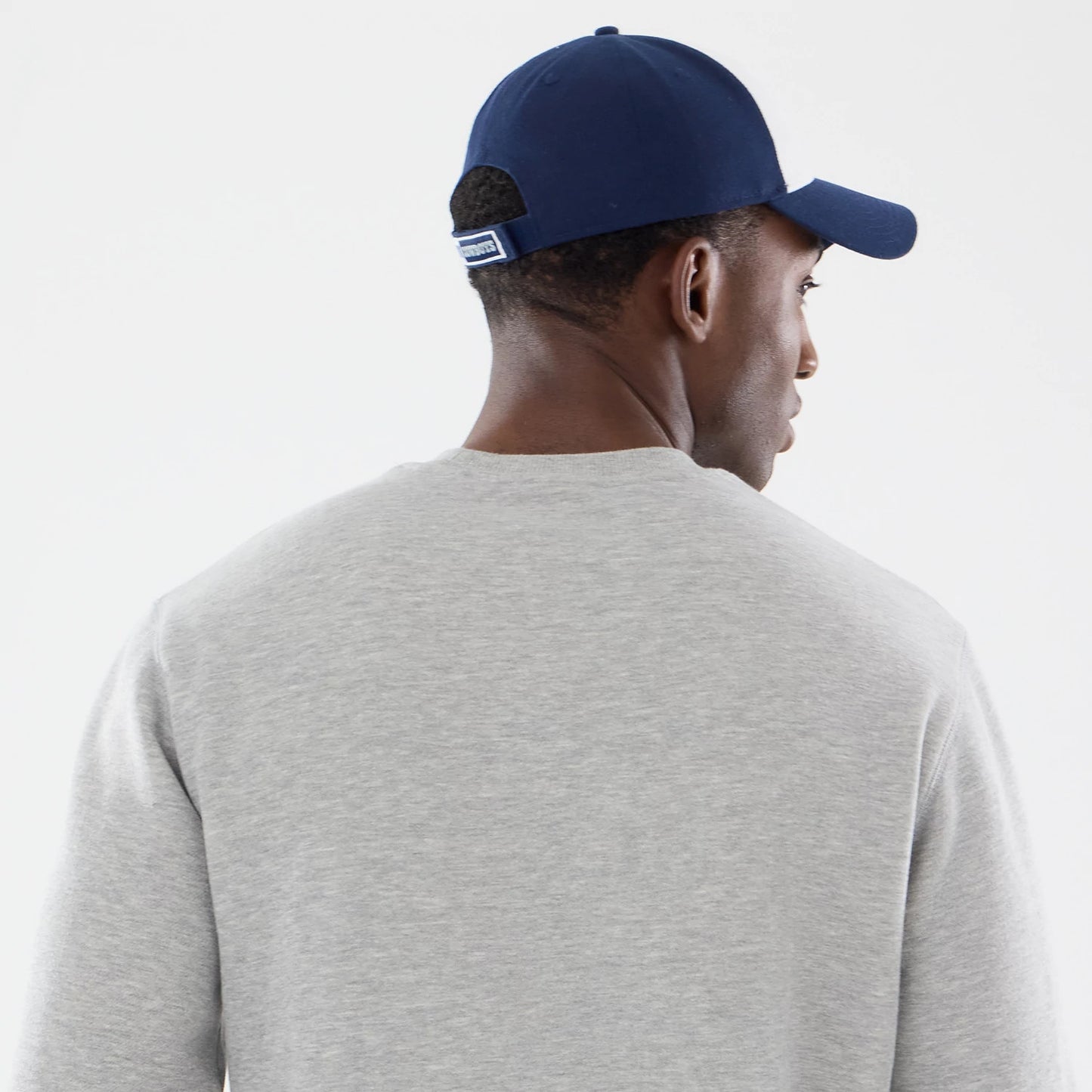 The model is wearing this NFL Training 2026 Dallas Cowboys Crew Neck Sweater in grey. 5