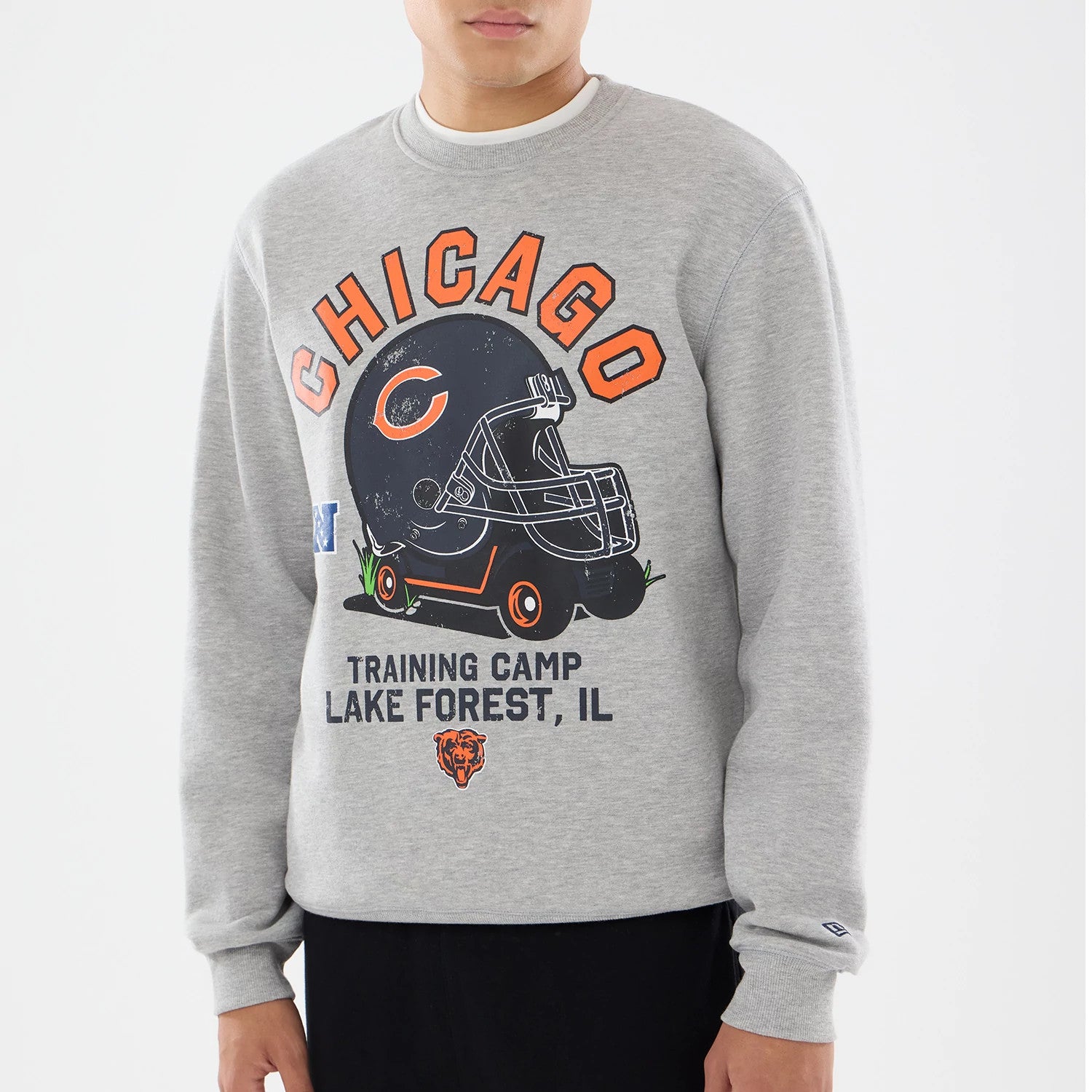 The model is wearing this NFL Training 2026 Chicago Bears Crew Neck Sweater in grey. 3