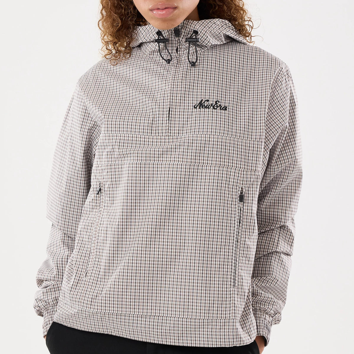 The model is wearing this Womens New Era Check Oversized Windbreaker Jacket in beige. 3