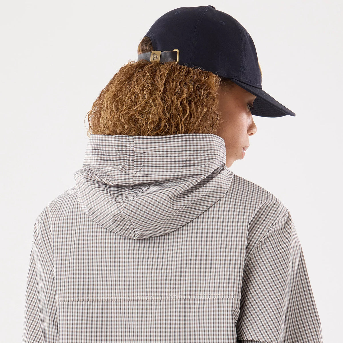 The model is wearing this Womens New Era Check Oversized Windbreaker Jacket in beige. 7