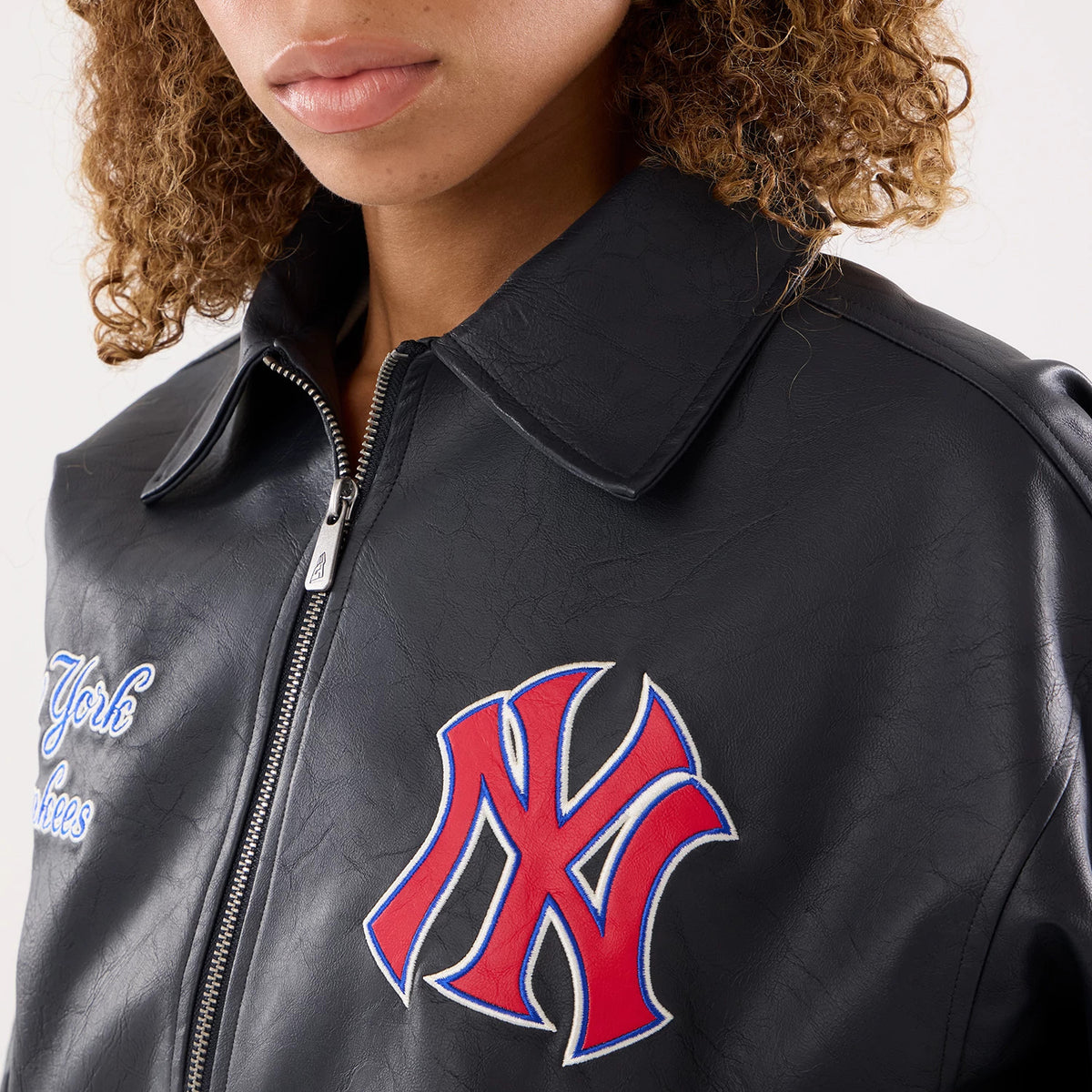 The model is wearing this Womens MLB New York Yankees Collared Jacket in navy. 5