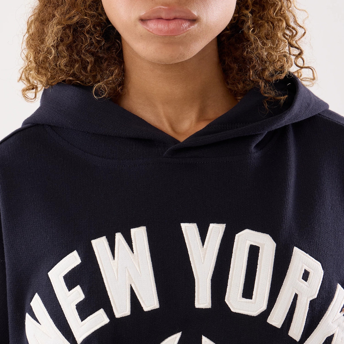 The model is wearing this Womens MLB New York Yankees Oversized Pullover Hoodie in navy. 5