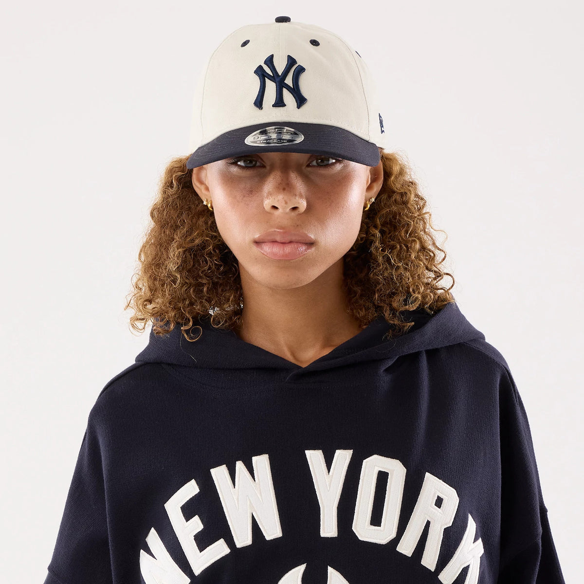 The model is wearing this Womens MLB New York Yankees Oversized Pullover Hoodie in navy. 7