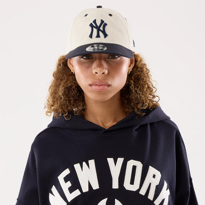 The model is wearing this Womens MLB New York Yankees Oversized Pullover Hoodie in navy. 7
