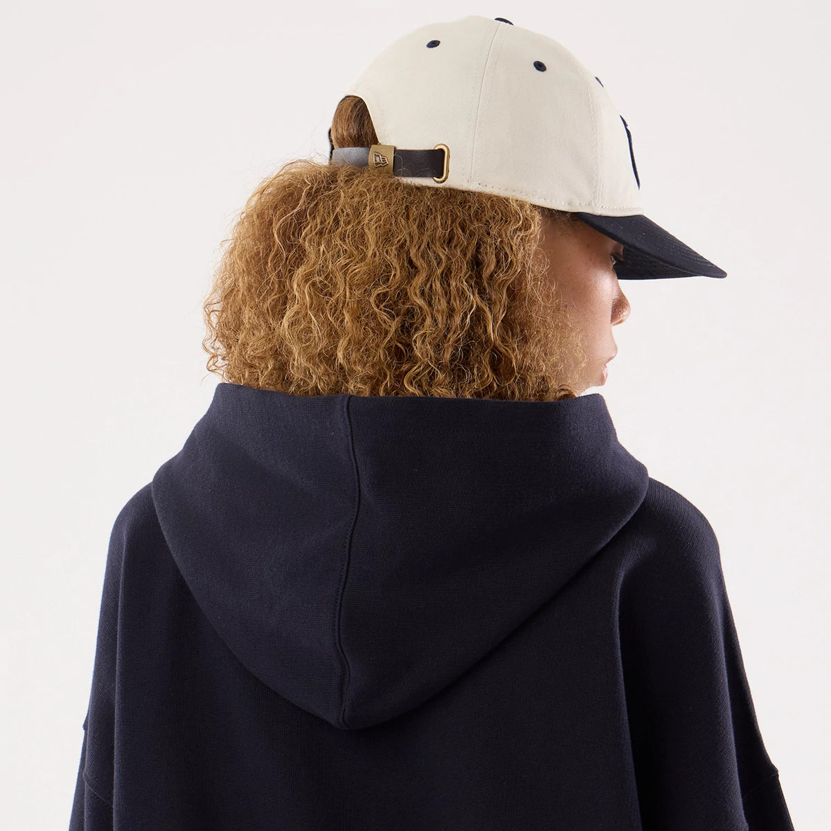 The model is wearing this Womens MLB New York Yankees Oversized Pullover Hoodie in navy. 4