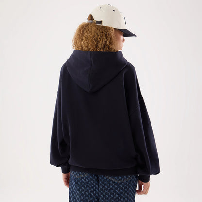 The model is wearing this Womens MLB New York Yankees Oversized Pullover Hoodie in navy. 2