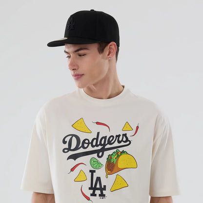 The model is wearing this MLB Food Graphic LA Dodgers Oversized T-Shirt in open white. 6